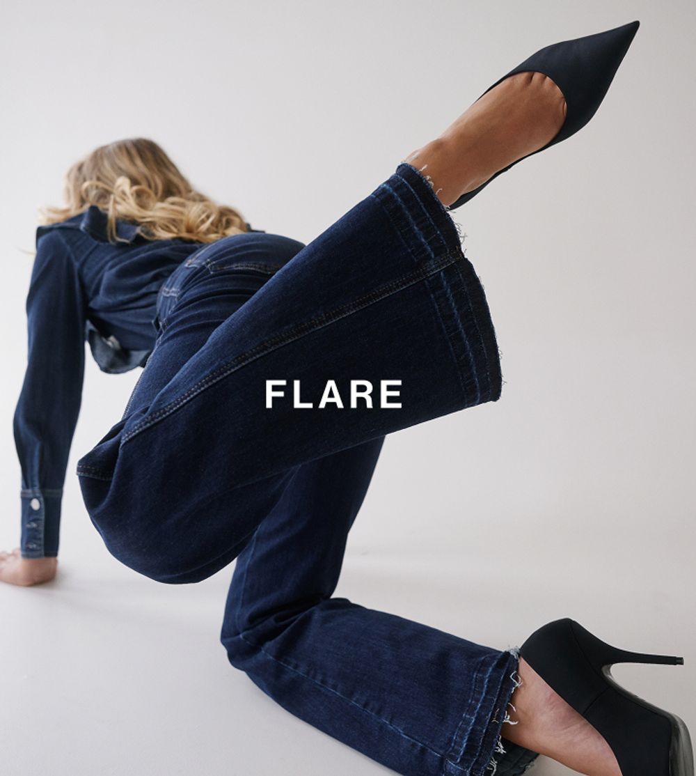 Model in a modern pose, wearing a matching denim set which has text overlay flare