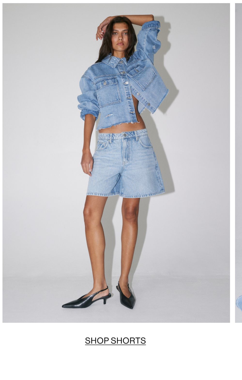 Woman posing in double denim shorts with text overlay shop shorts