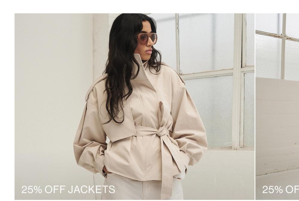 Woman wearing a almond trench looking to the side