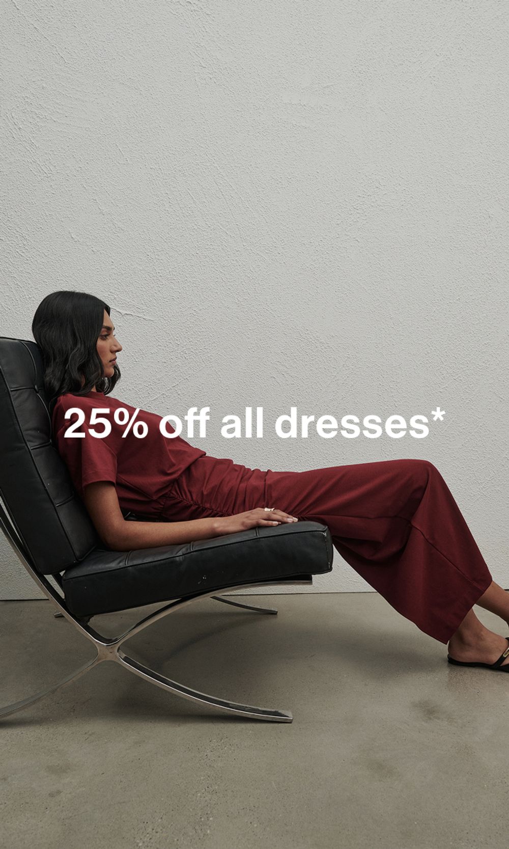 Model in a red dress, sitting on couch. Text reads ‘25% off all dresses'