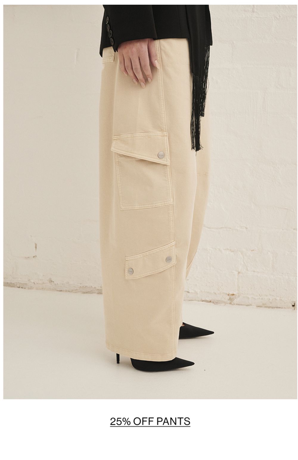 Woman posing in almond colour pants with text overlay shop pants