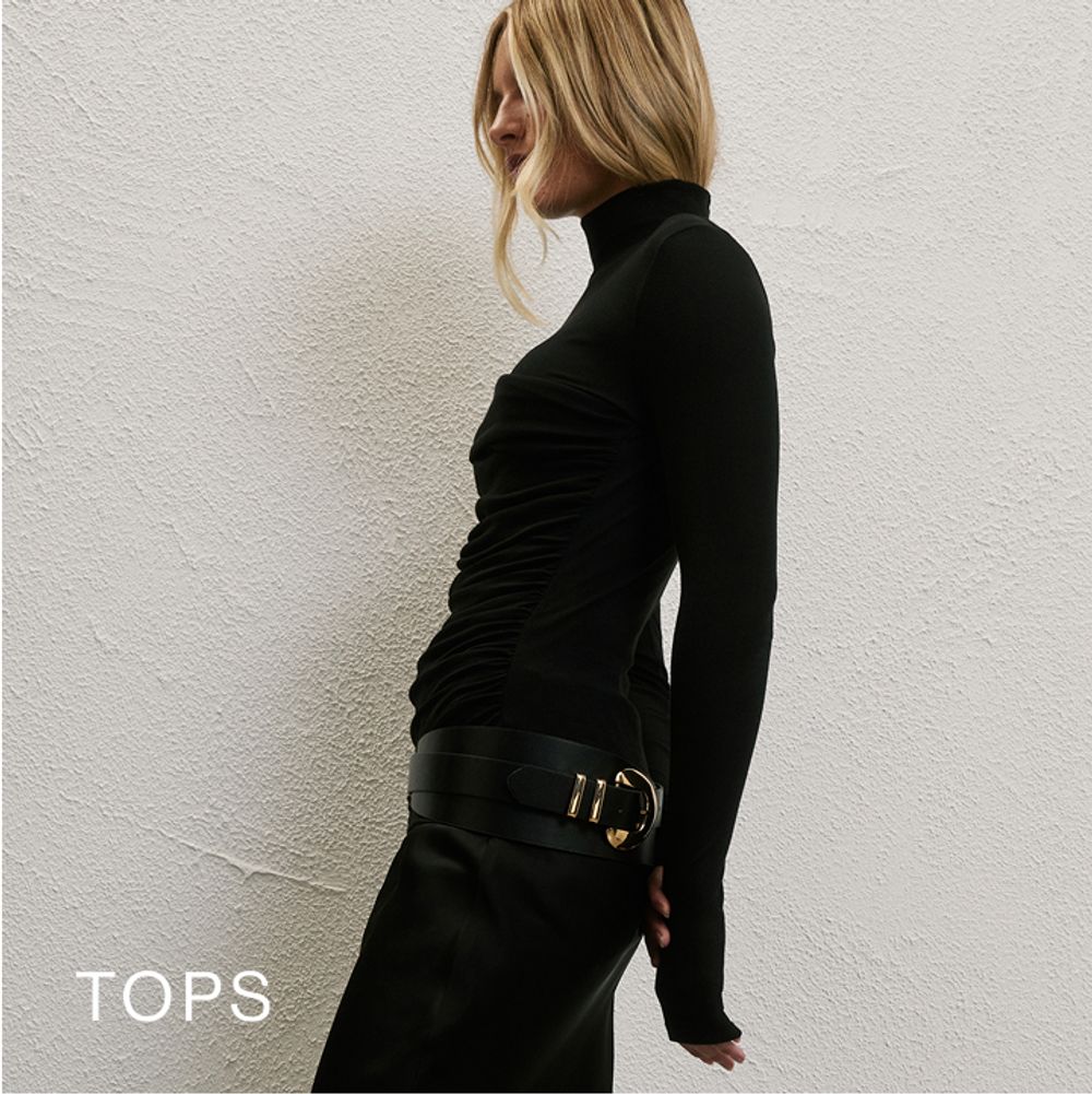 Woman standing in front of a white wall wearing a blue fluffy coat and blue skirt with text that reads "25% off new"