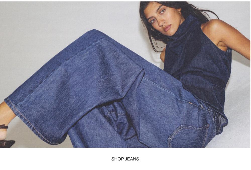 Woman in double denim with text overlay "SHOP JEANS"