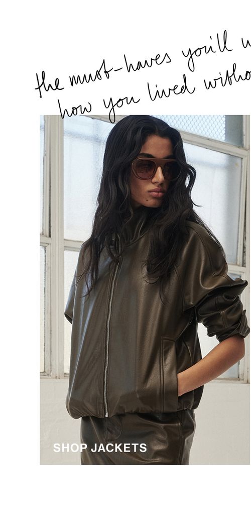 Woman standing in a brown funnel neck jacket