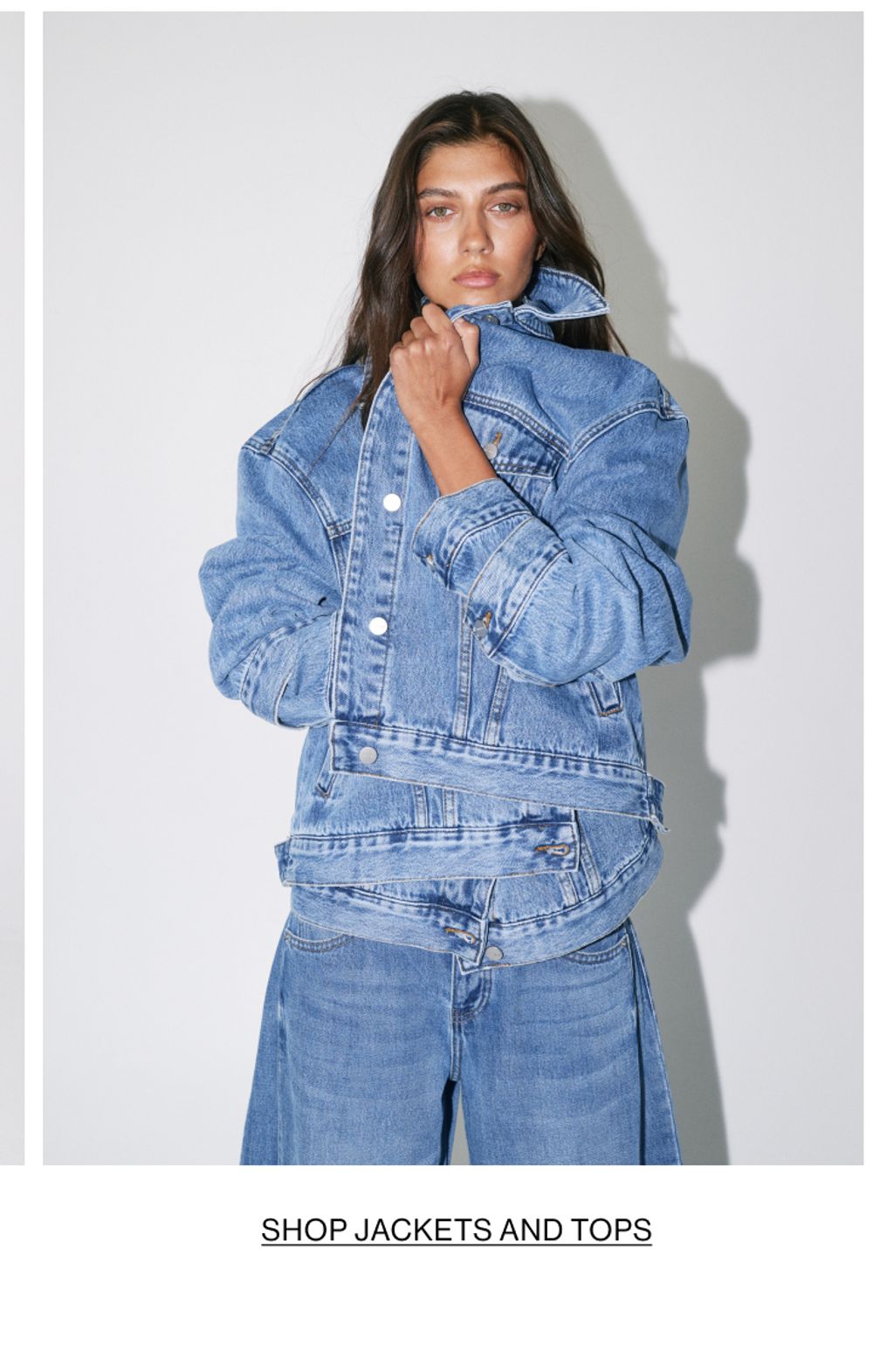 Woman posing in a denim jacket with text overlay Shop jackets and shirts