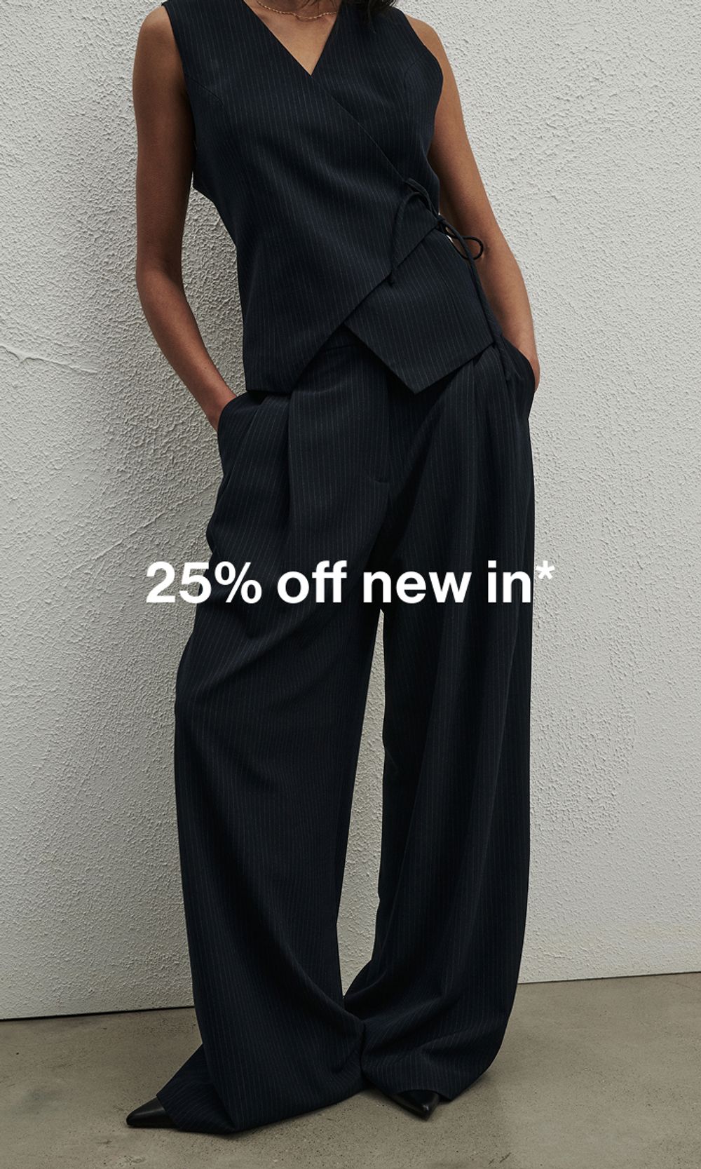 Model in a blue pinstripe coordinated set, standing casually. Text reads ‘25% off new in'