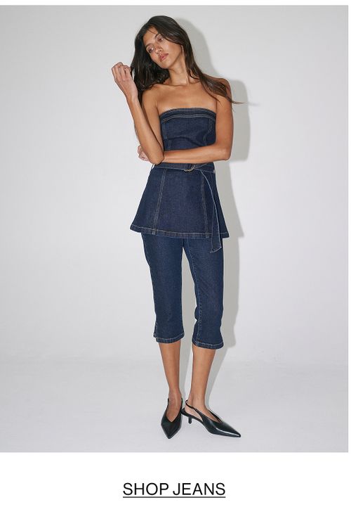 Woman in double denim with text overlay "SHOP JEANS"