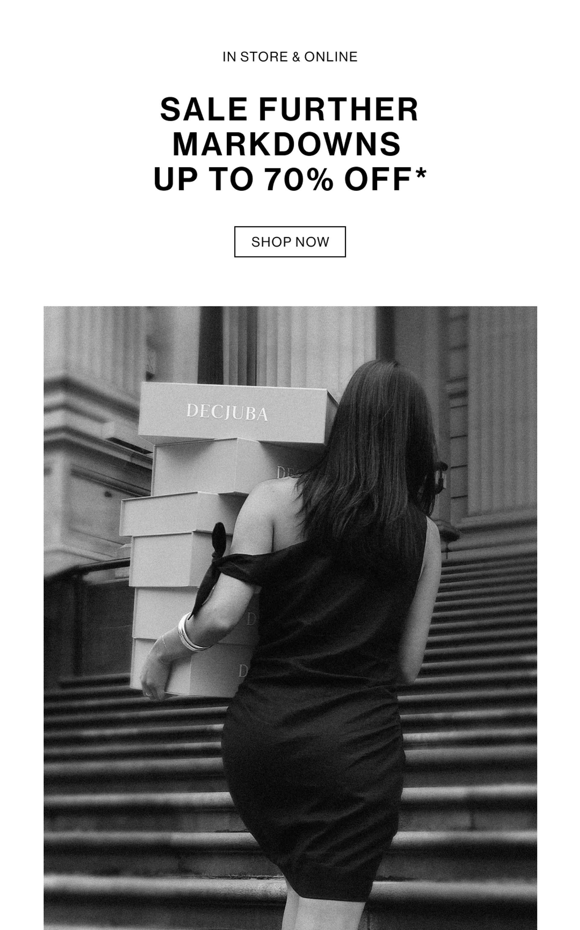 Woman in a black dress carrying boxes labeled ‘Decjuba’ up stairs. Text reads ‘Sale: further markdowns up to 70% off.