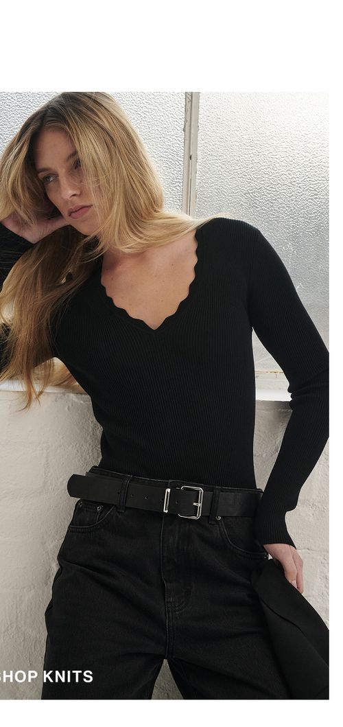 Woman posing in a black knit