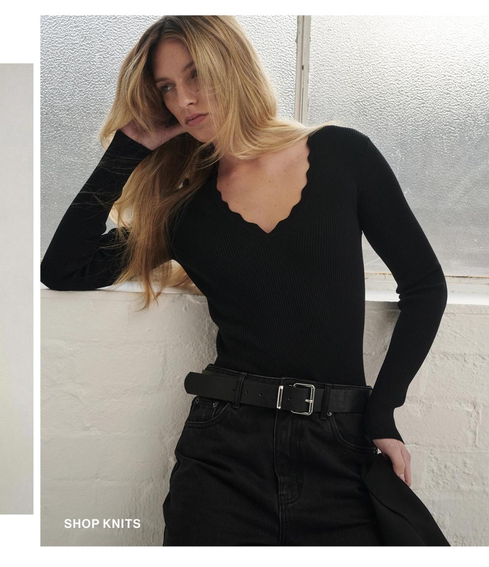 Woman posing in a black knit