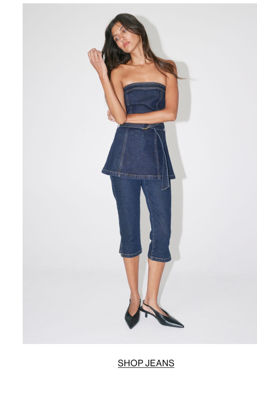 Woman posing is a denim capri set
