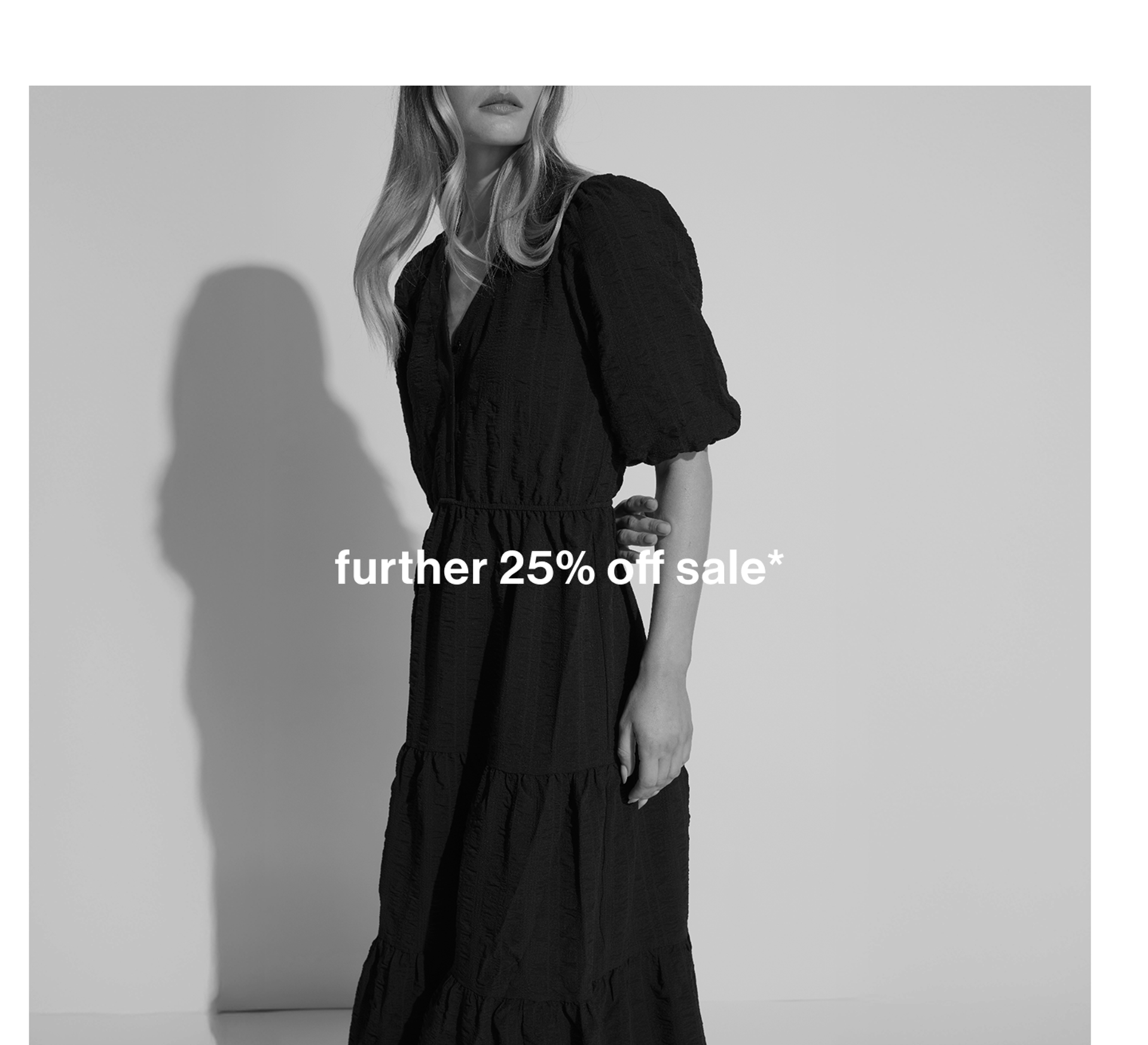 Black and white image of woman in dress. Text reads "further 25% off all sale"