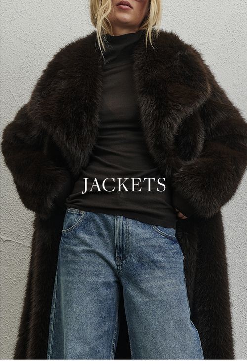 Woman standing in front of a white wall wearing fur coat and sunglasses with text overlay which states "Jackets"