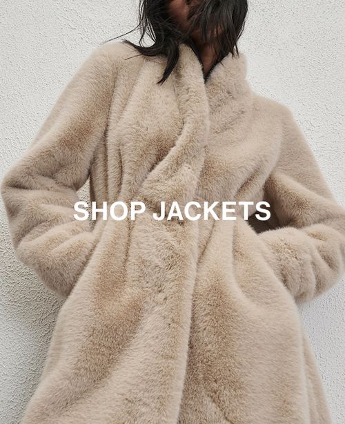 Woman sitting in front of a white wall wearing cream fur jacket with text overlay which states "20% off Jackets"
