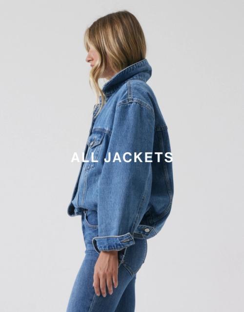 Model standing on her side wearing a matching denim set which has text overlay jackets