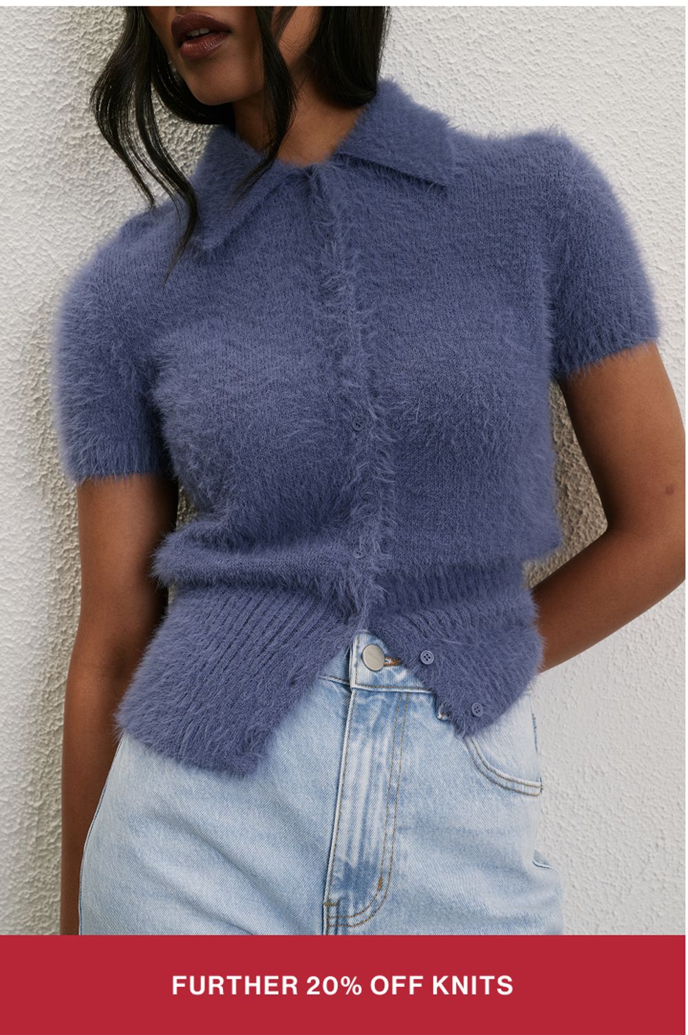 Woman wearing a blue knit jumper with text overlay "further 20% off knits"