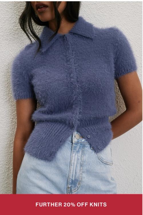 Woman wearing a blue knit jumper with text overlay "further 20% off knits"