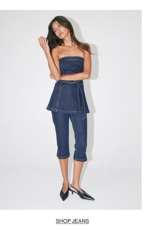 Woman posing is a denim capri set