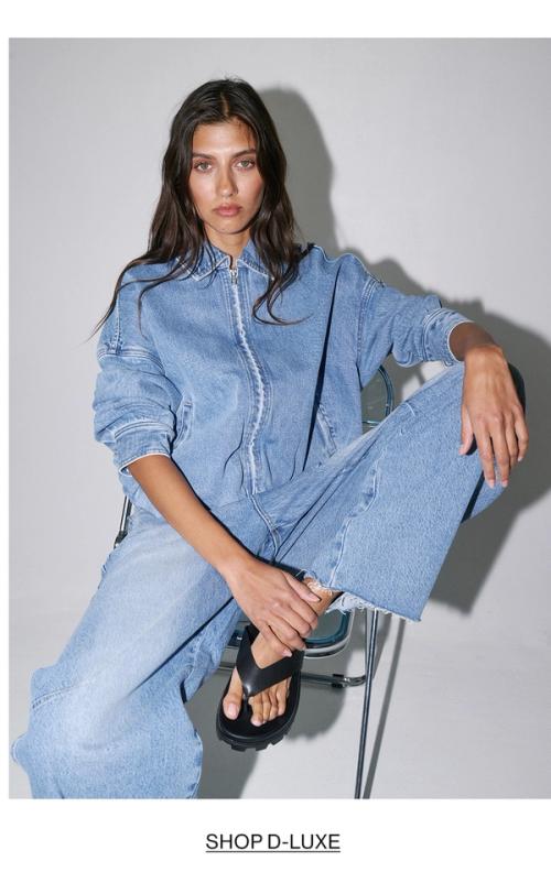 Woman posing in double denim with text that states shop Dluxe