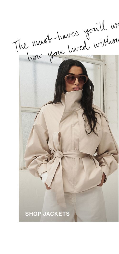 Woman standing in a cream trench jacket