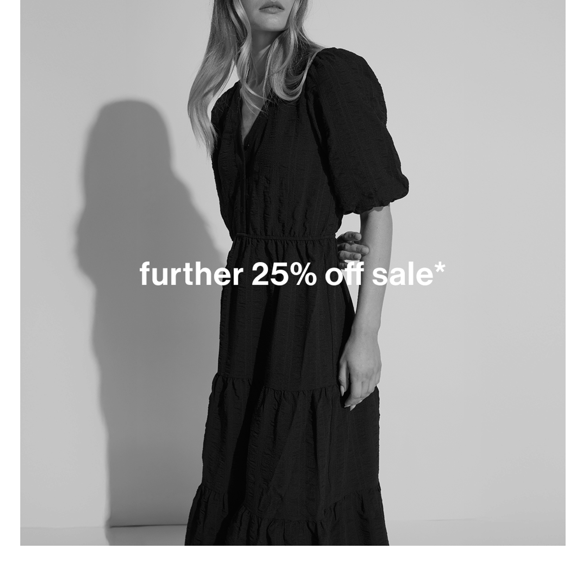 Black and white image of woman in dress. Text reads "further 25% off all sale"