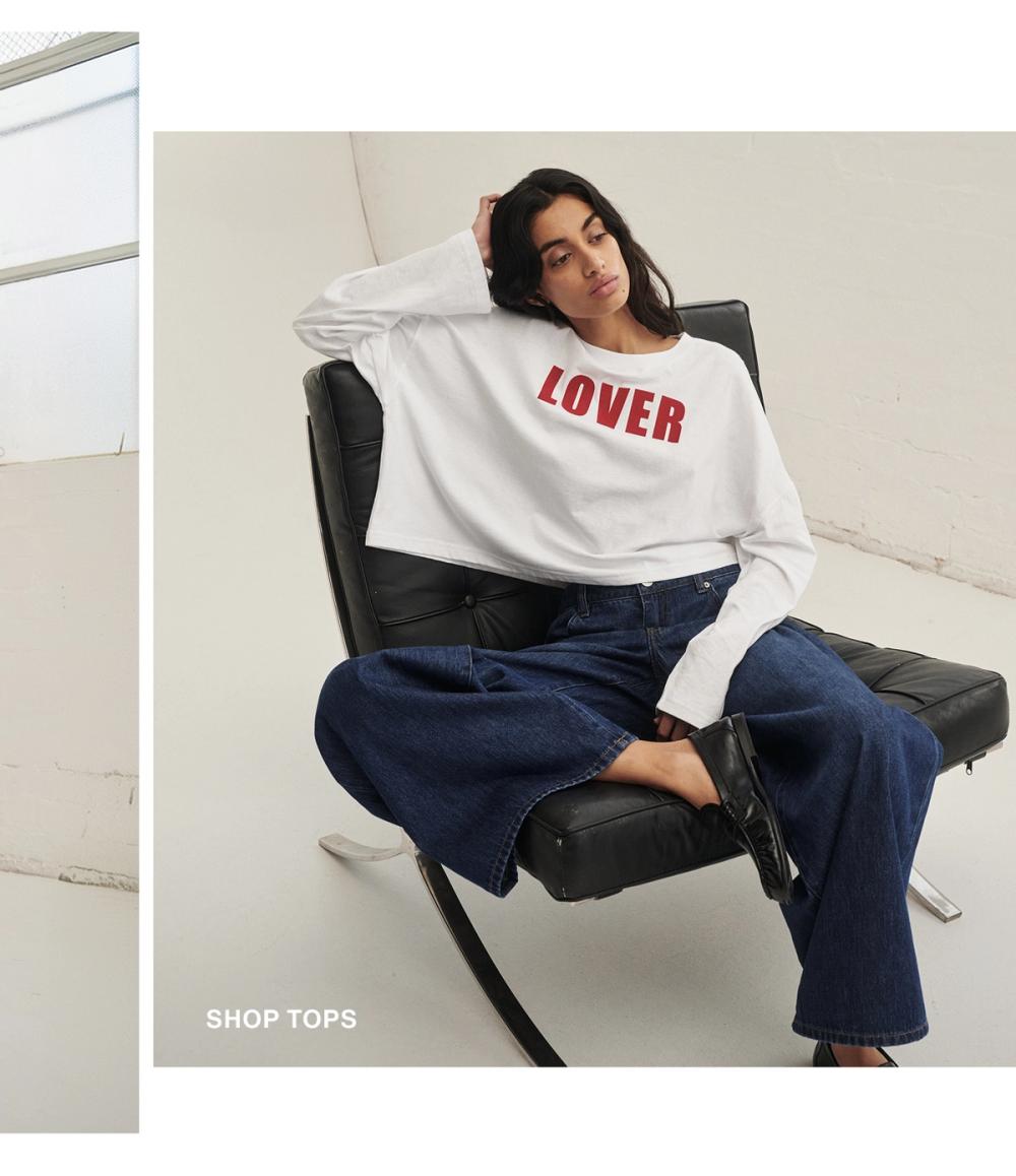 Woman posing in a long sleeve top that has lover on it