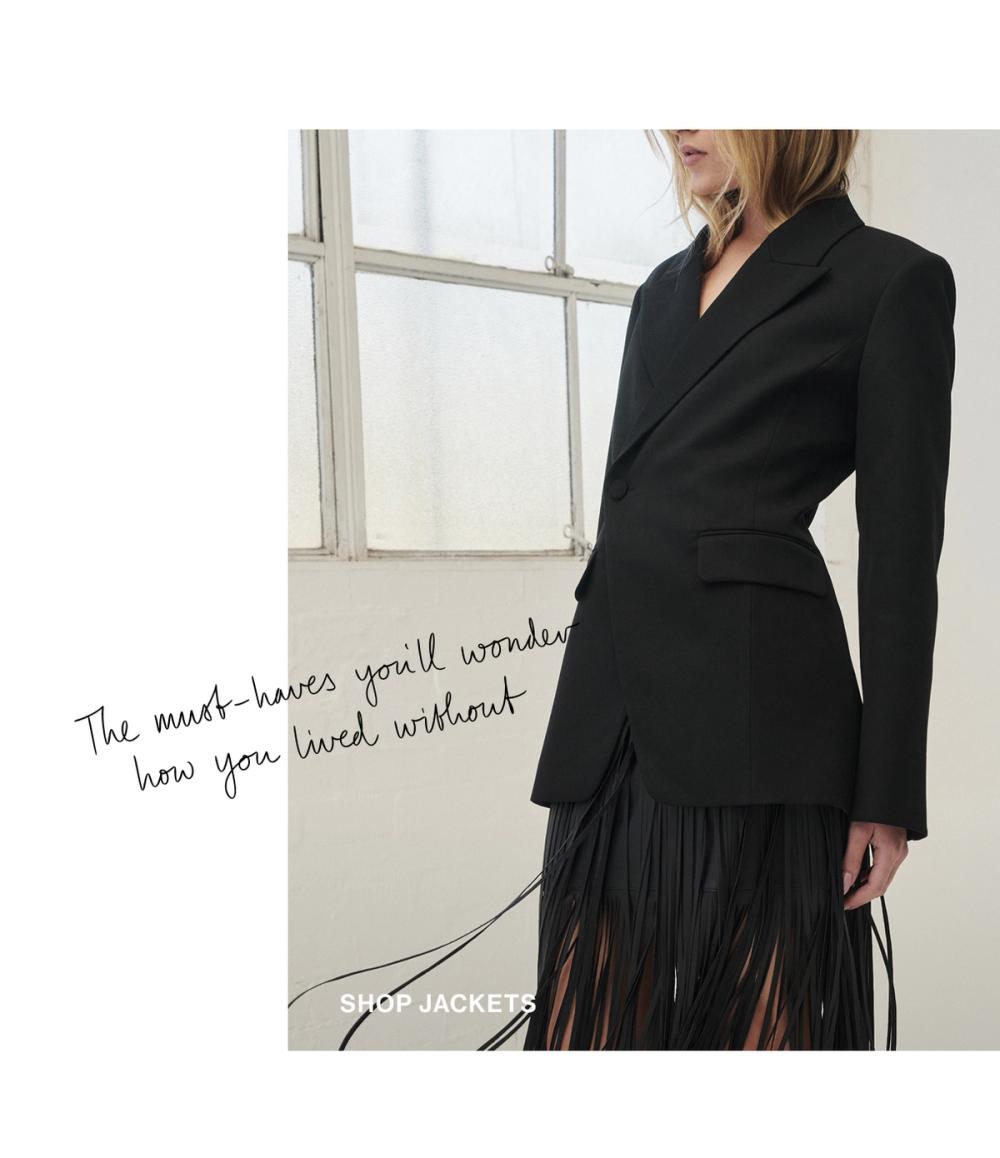 Woman standing in a black suit coat