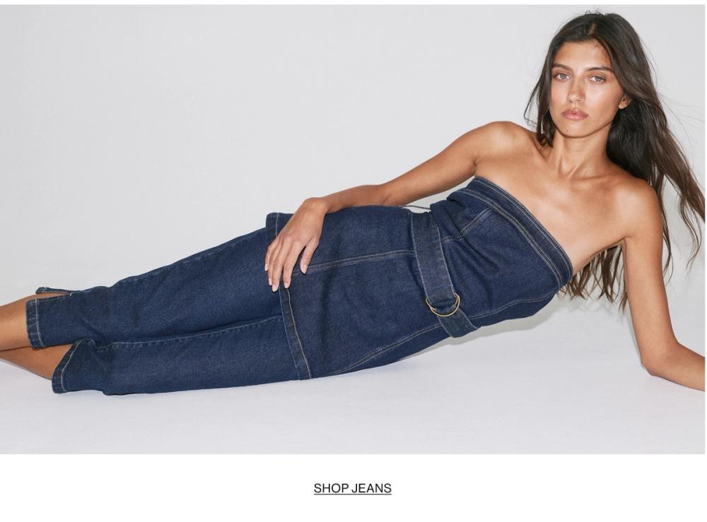 Woman in double denim with text overlay "SHOP JEANS"