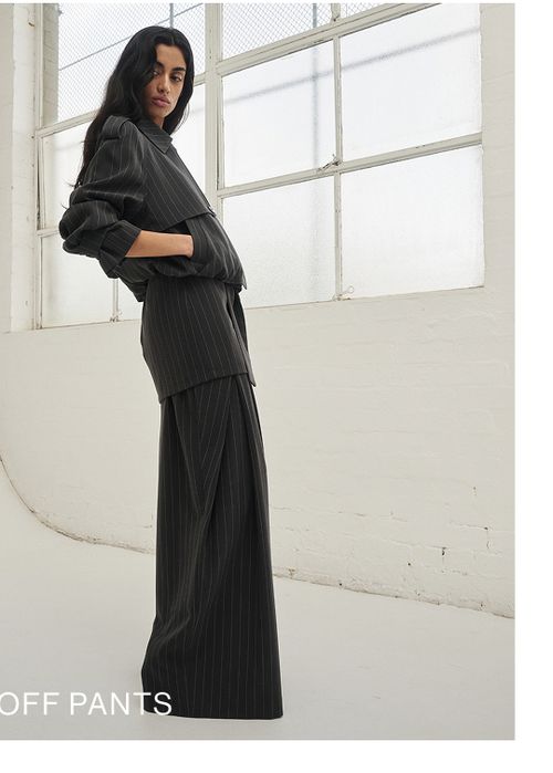 Woman posing in a pinstripe suit 