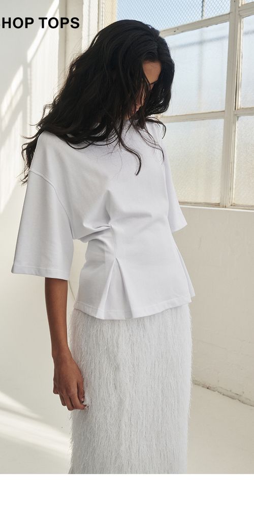 Woman posing in a white top 