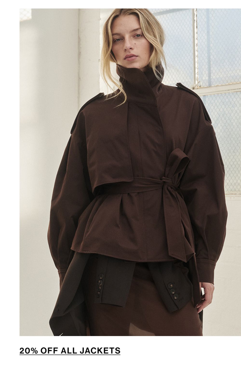 Woman standing in a black funnel neck jacket