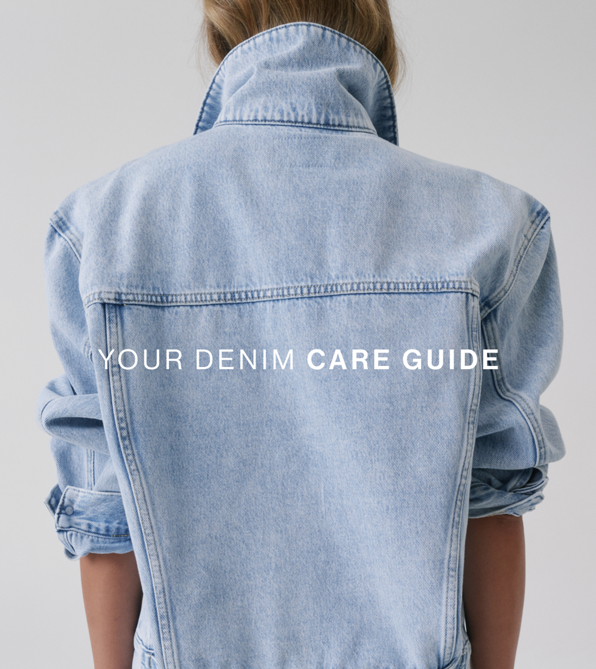 Model photographed from behind wearing a light blue denim jacket with the collar turned up. Large overlay text reads “Your Denim Care Guide.”