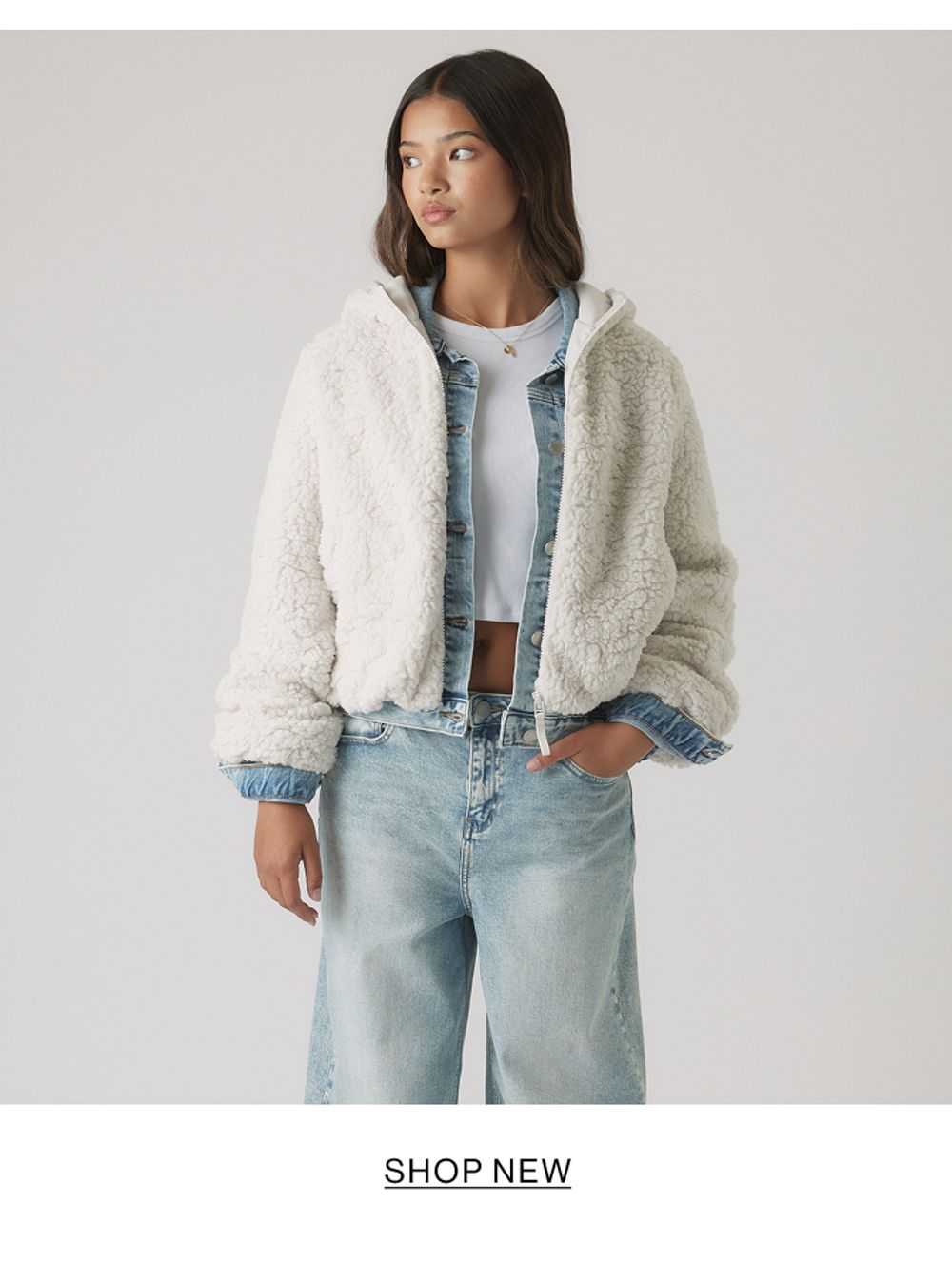 Girl wearing a cream shearling jacket and jeans – Kids New In.