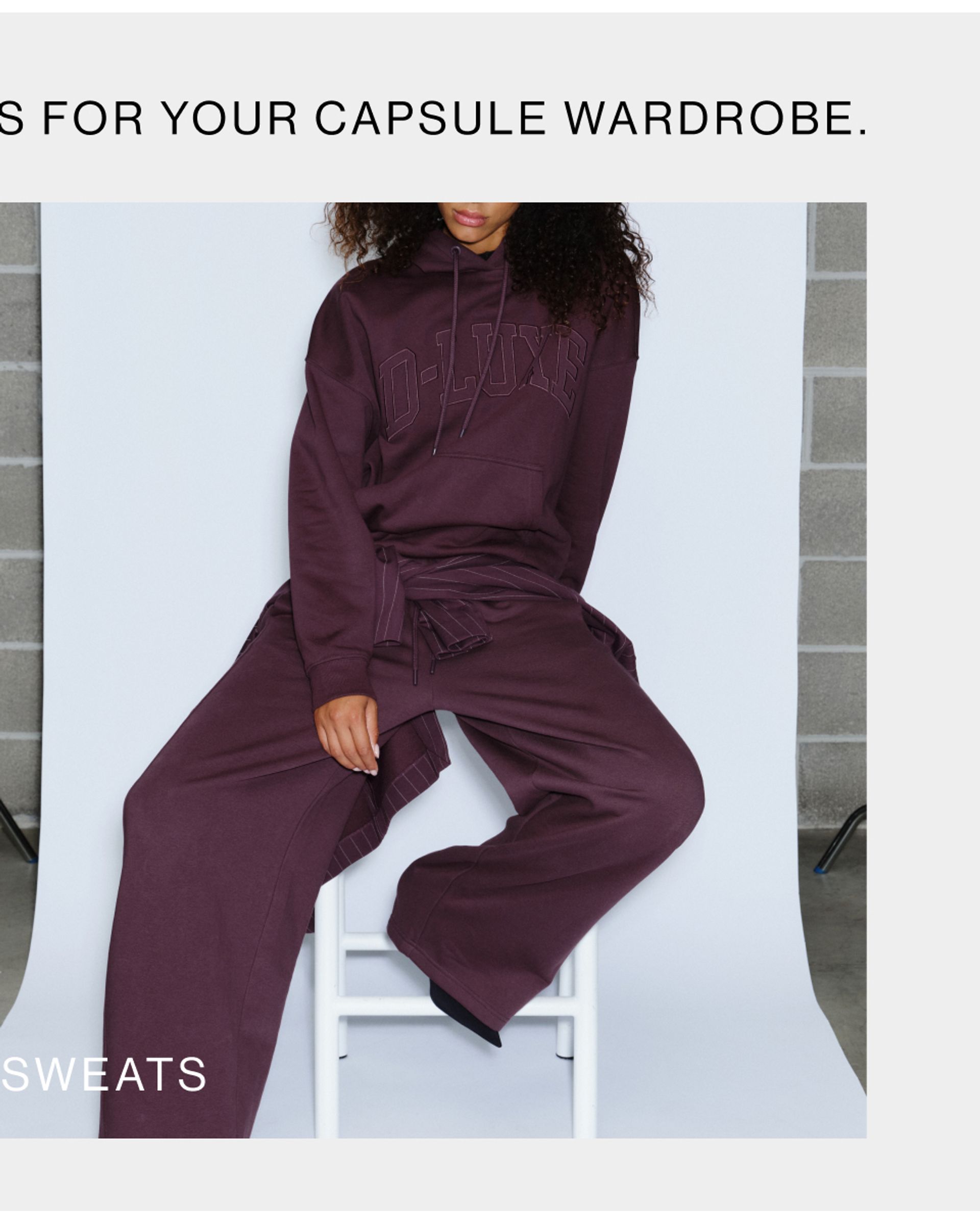 Model wearing a sweat set in midnight cherry in studio. SHOP D-LUXE SWEATS.