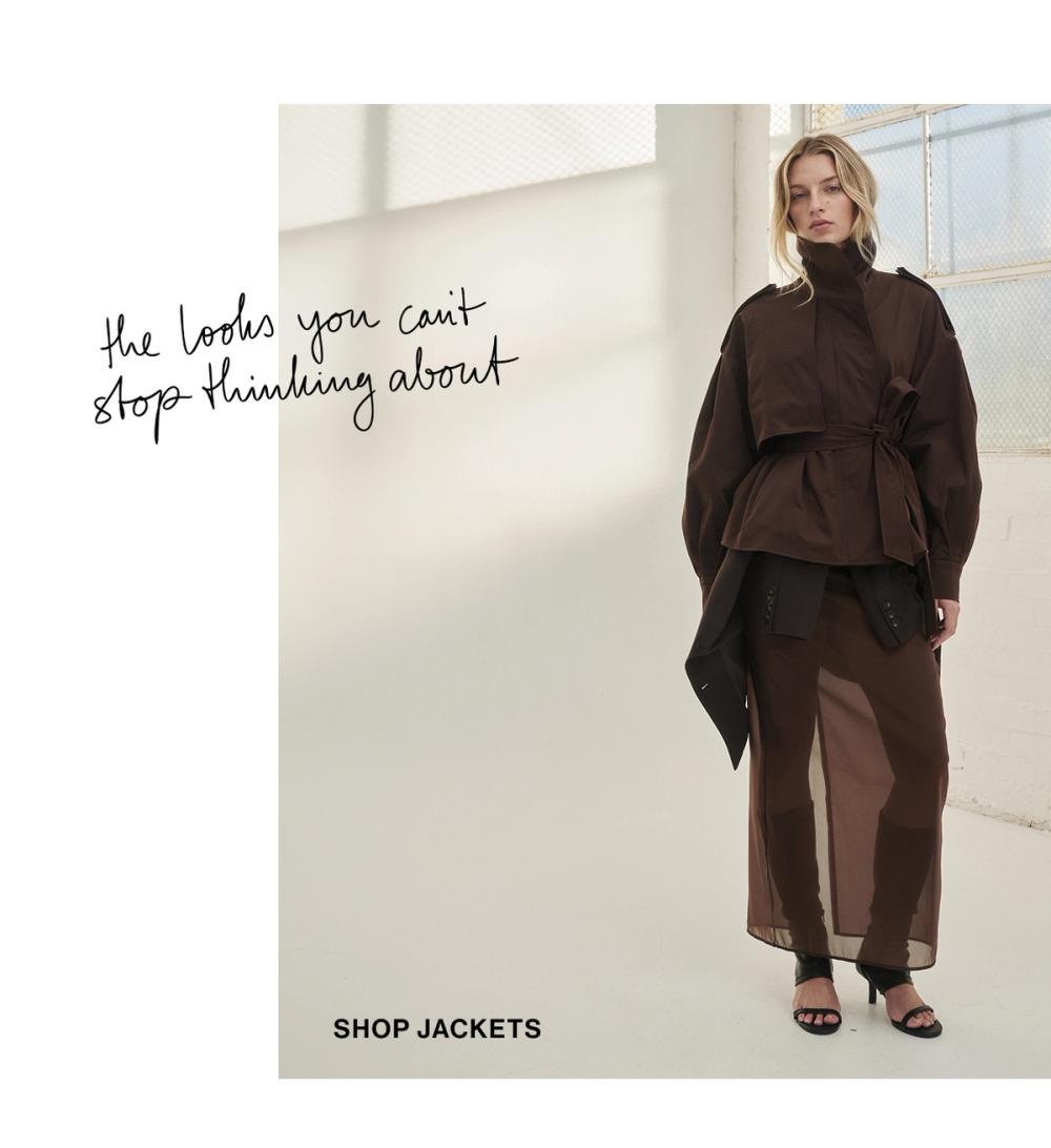 Model posing in a brown cropped trench jacket. SHOP JACKETS