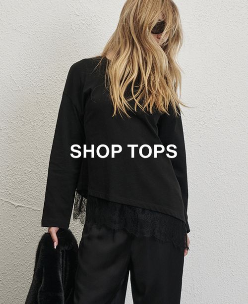 Model wearing a black long sleeve stripe shirt. SHOP TOPS.