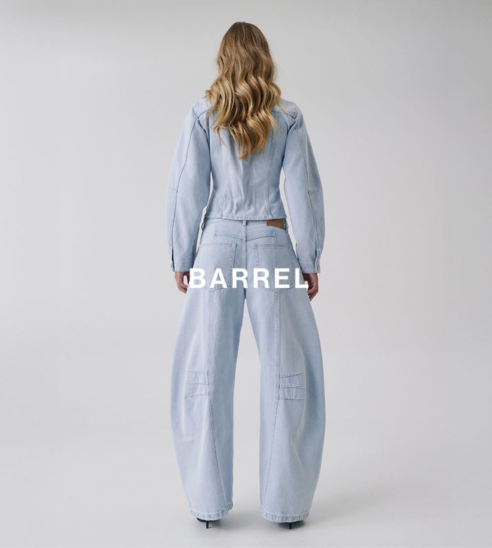 Back view of model in light barrel-leg jeans – Barrel fit.