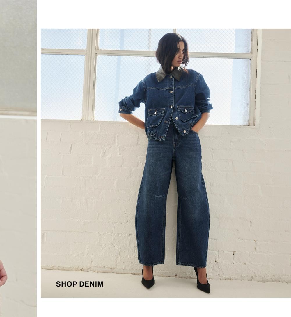 Model posing in a blue denim set. SHOP DENIM