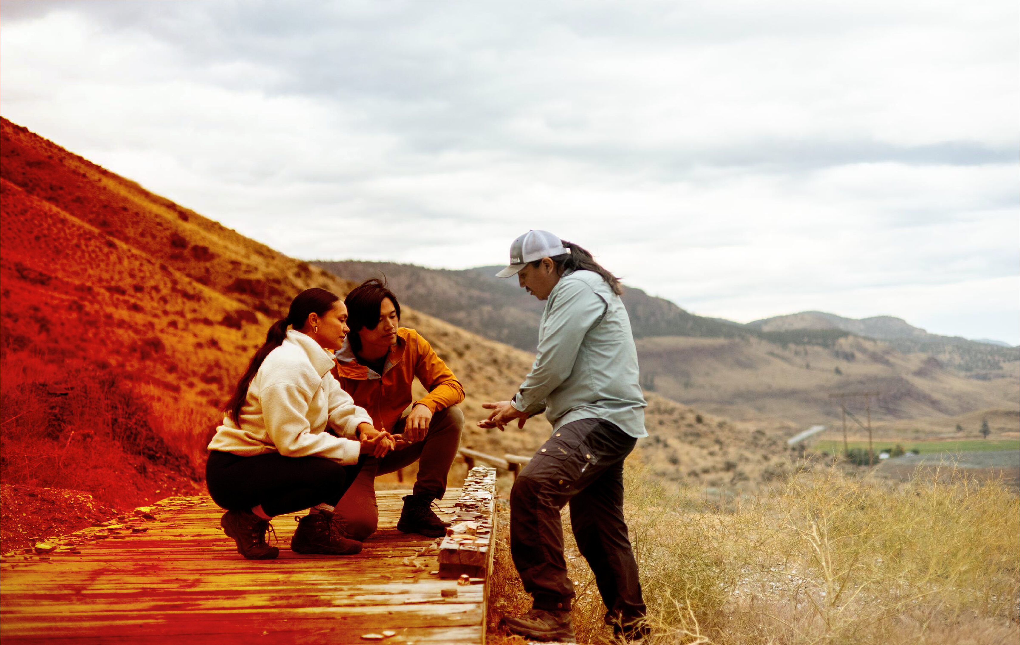 People outdoors on a sunlit trail.