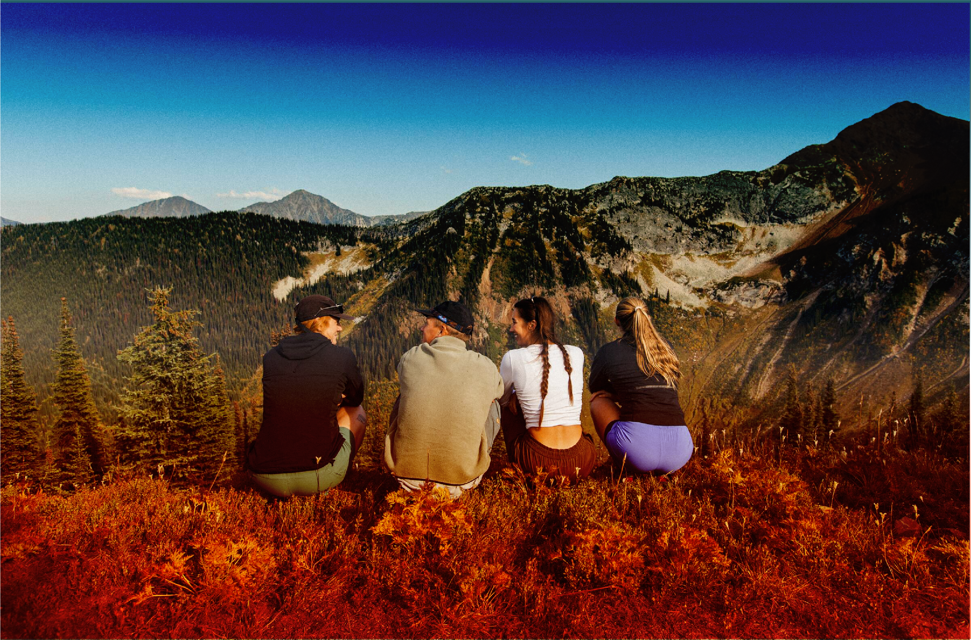 Friends looking over a mountain view.