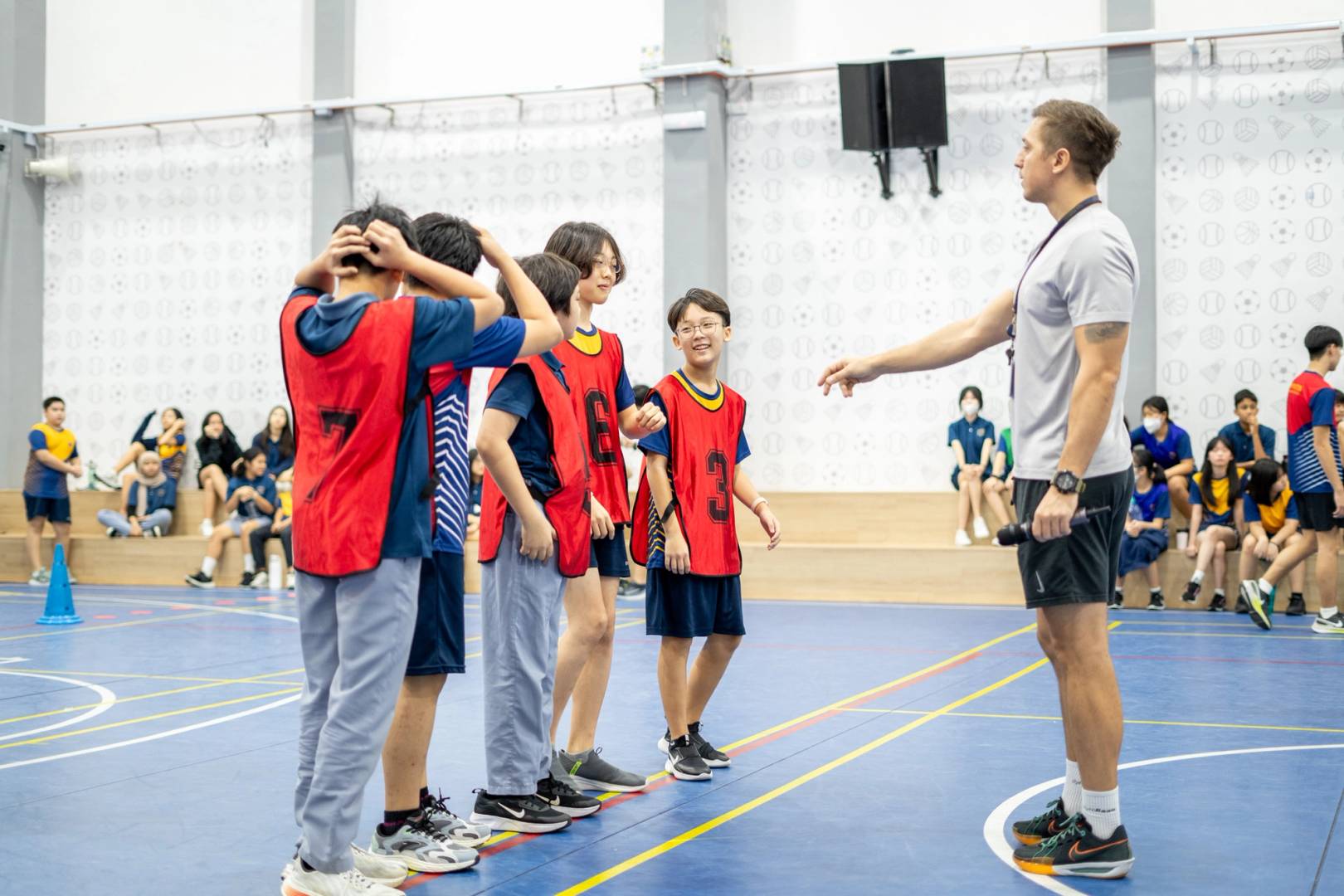 Coach giving Red team advice on a basketball court