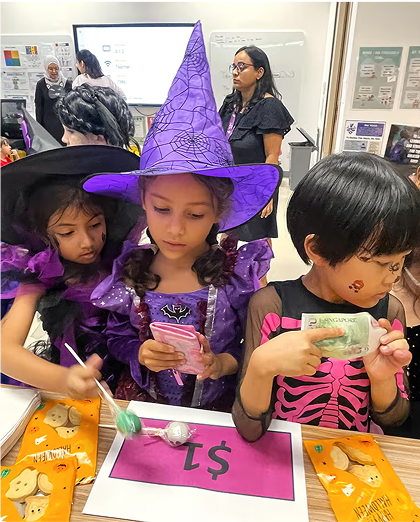Invictus students dressed in Halloween costumes participating in a fun and interactive classroom celebration.