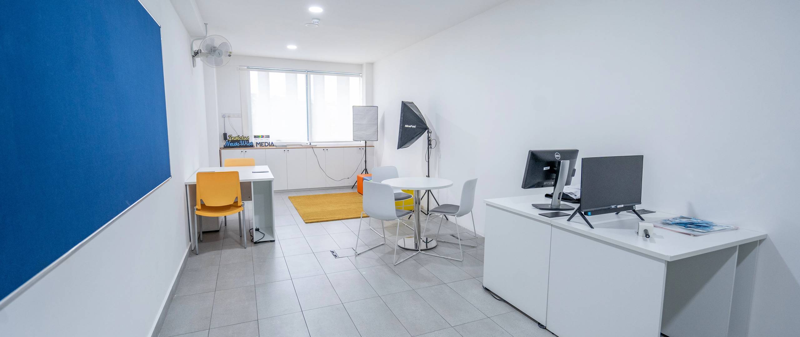 Media or interview room with white walls and minimal setup.