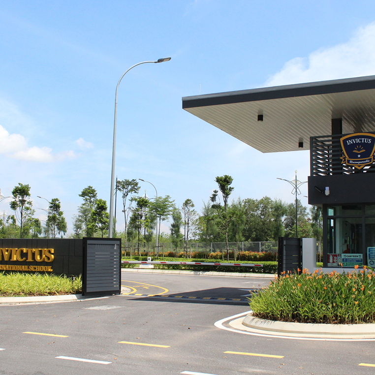 Front entrance of Horizon Hills Invictus International School Malaysia, featuring modern security gates and landscaped surroundings.