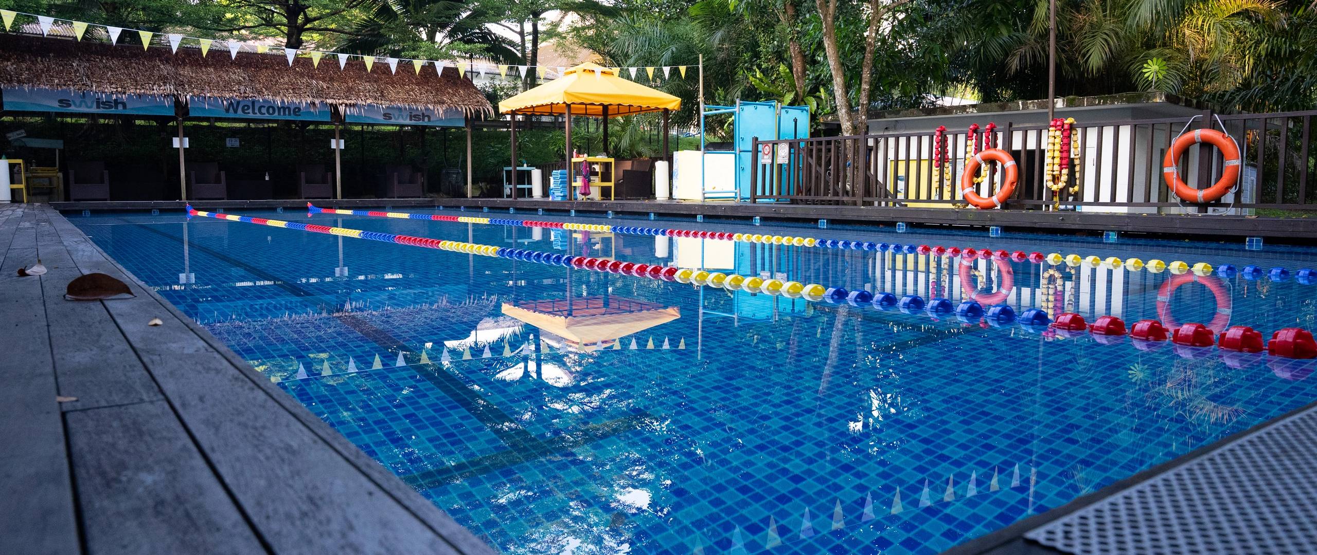 Invictus Dempsey swimming pool with lap lanes and shaded seating area.