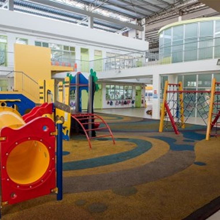Invictus International School Malaysia Spring Hills Campus indoor playground area with colorful slide and climbing structures