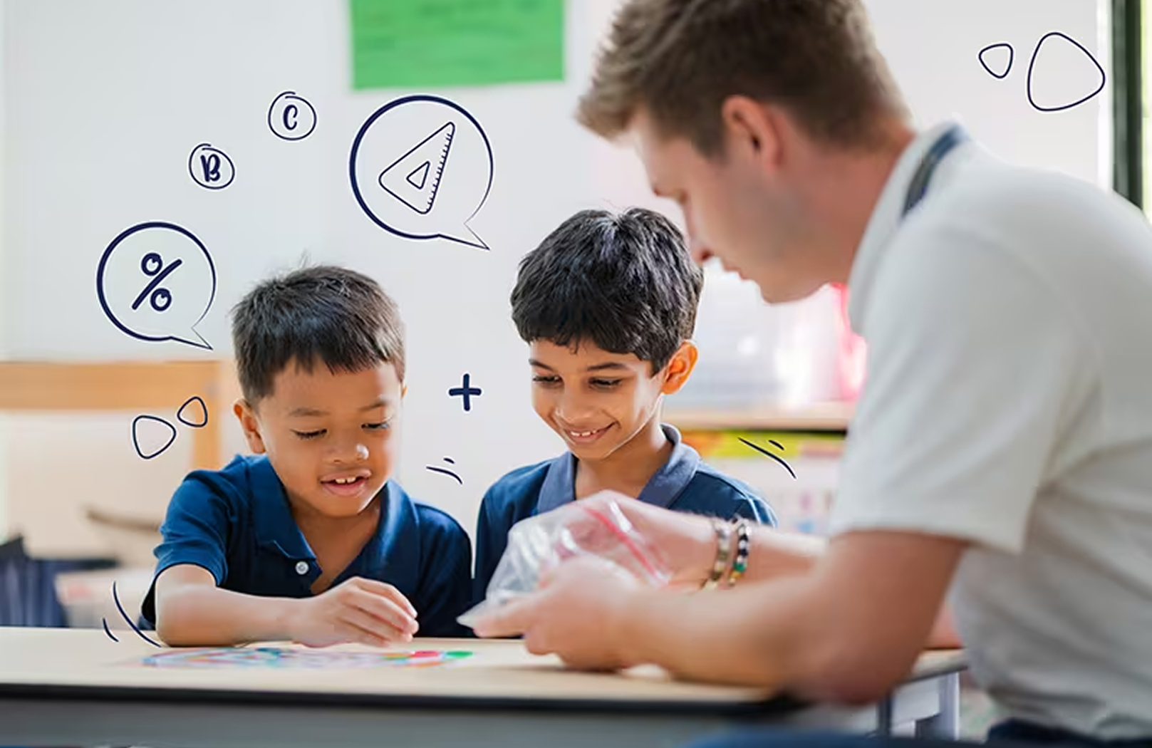 Two boys smile while participating in a fun maths activity with their teacher, exploring numeracy concepts through interactive learning at Invictus International School.