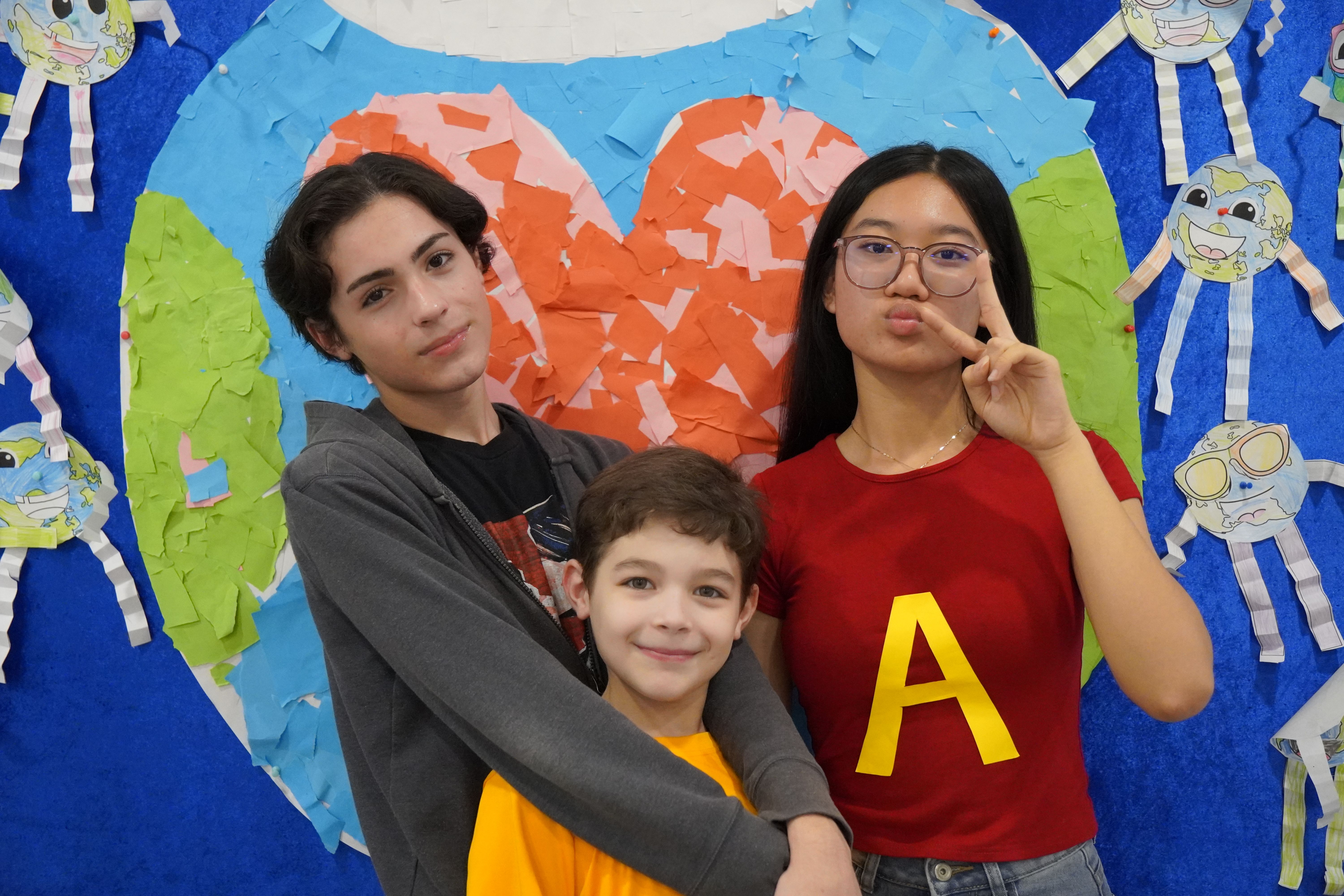 Two primary students working together on a laptop in a classroom marked “Library”.