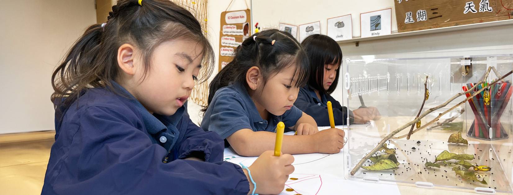 Young student at Invictus International School Hong Kong engaging in playful learning outdoors in school uniform