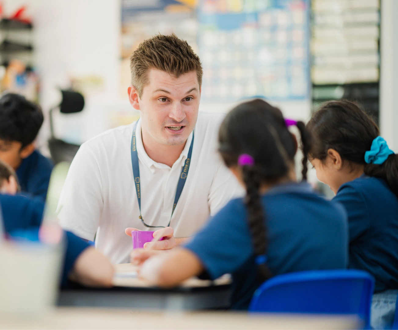 Teacher teaching two students